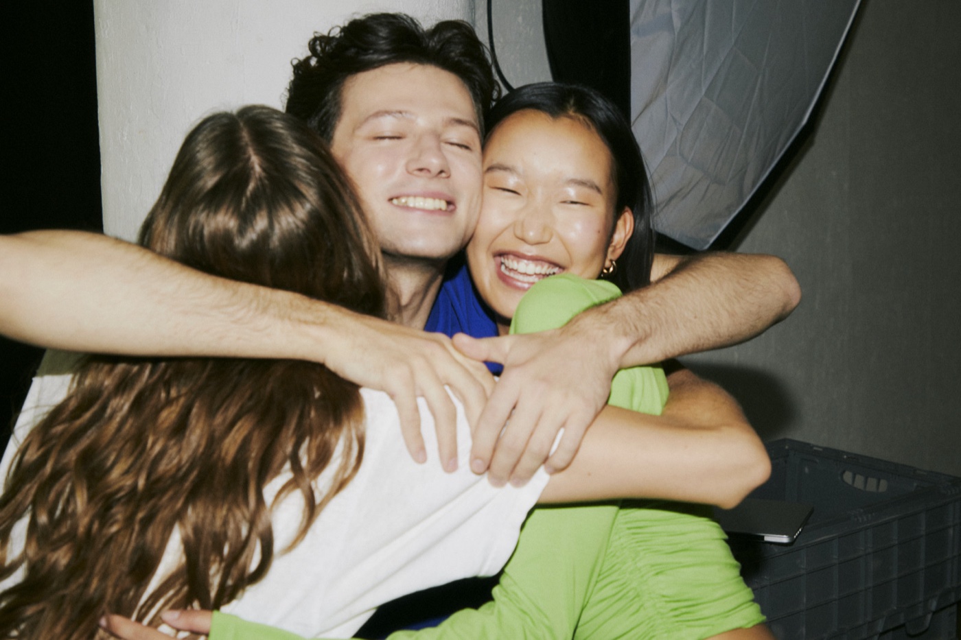 Three friends in a group hug